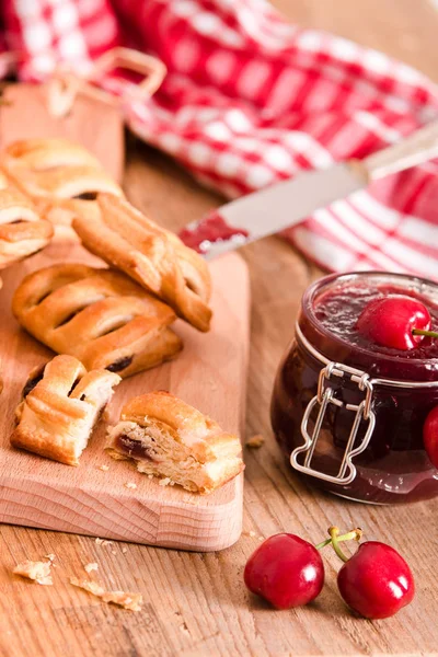 Cherry pastry pies on cutting board. — Stock Photo, Image