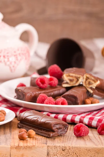 Chocolate rolls with hazelnuts and raspberries. — Stock Photo, Image