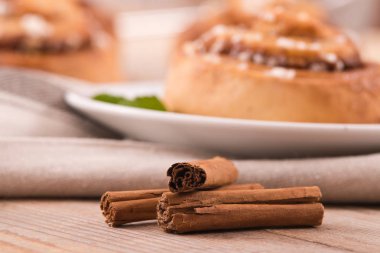 Cinnamon rolls on wooden table.  clipart