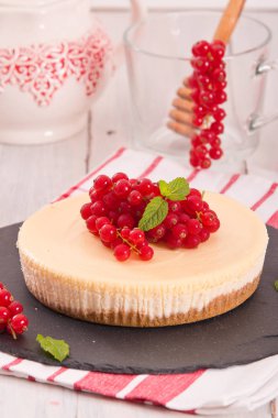 Somun cheesecake siyah çanak üzerinde. 