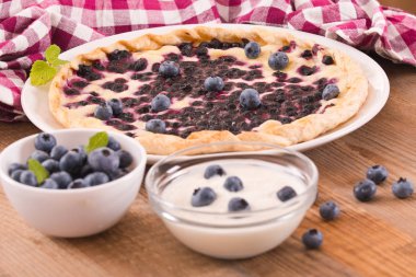 Beyaz çanak üzerinde üzümlü tart. 