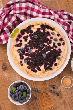 Beyaz çanak üzerinde üzümlü tart. 