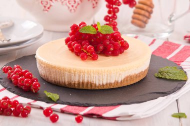 Somun cheesecake siyah çanak üzerinde. 