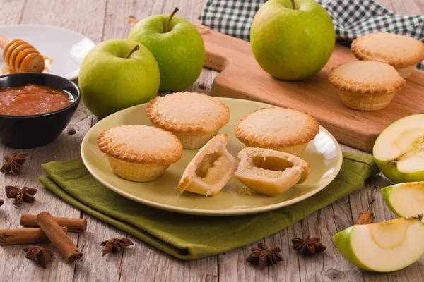 Apple pies on green dish.