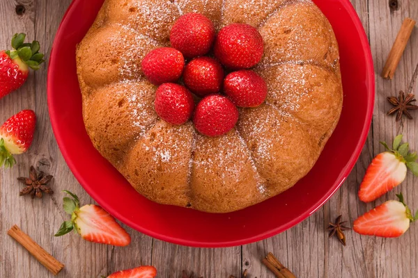 Strawberry cake on red dish.