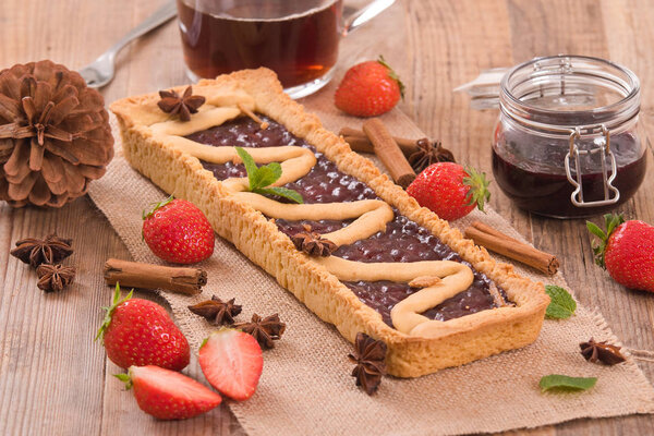 Strawberry tart on wooden table. 