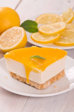 Limonlu cheesecake siyah çanak üzerinde. 