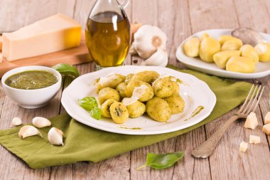 Potato gnocchi stuffed with pesto sauce on white dish. clipart