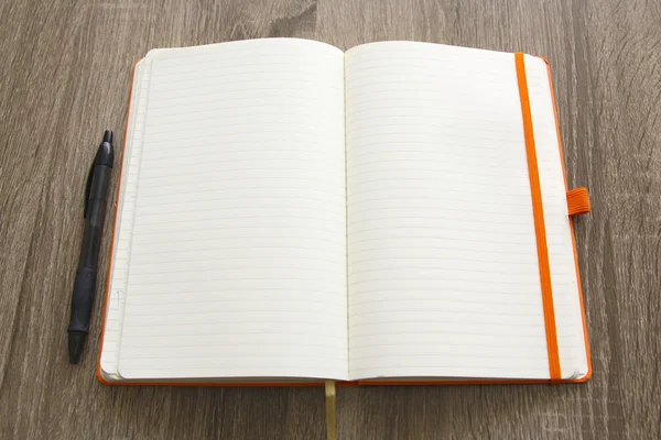 Leeres Notizbuch und Bleistift über grauem Holztischhintergrund — Stockfoto