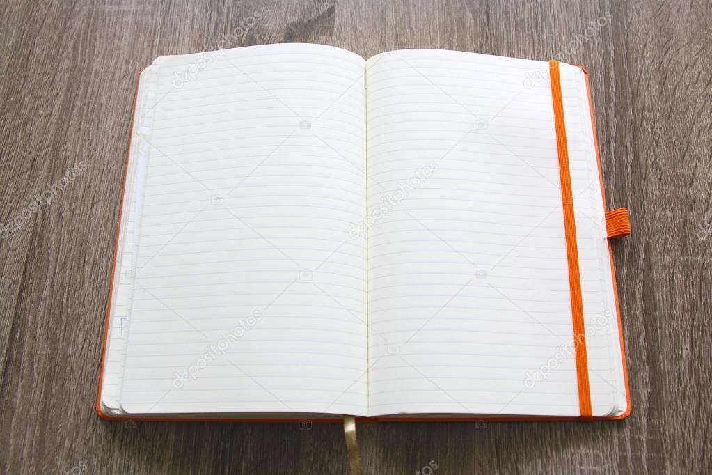 Blank Book over a grey Wood Table background