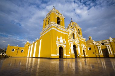 Magnificent yellow cathedral with a beautiful blue sky and light reflections in Trujillo, Peru clipart