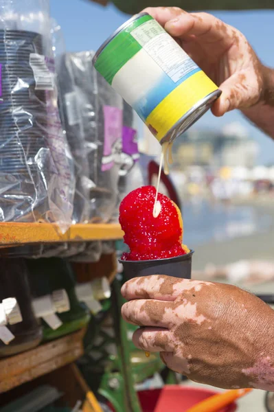 Fruit and ice cream vendor in action at Bocagrande Beach, Cartegena, Columbia