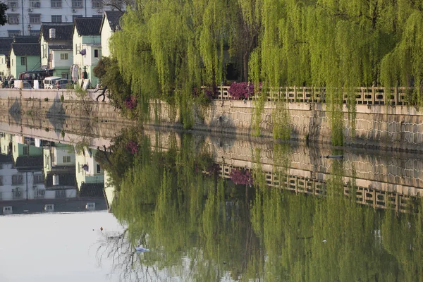 Residential buildings, trees and Small water canal in Qibao, Shanghai, China 2013.