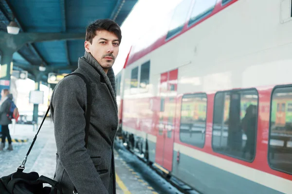 Человек стоит на железнодорожной платформе — стоковое фото