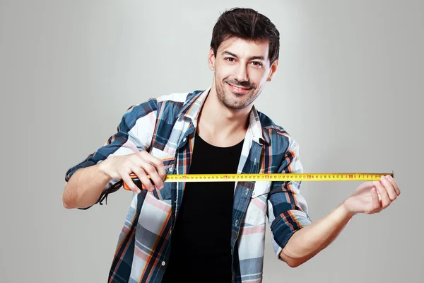 Man holding measurement tape — Stock Photo, Image