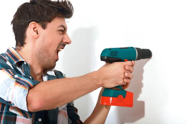 Man going mad holding drill — Stock Photo, Image