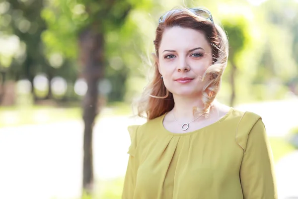 Femme aux cheveux blonds debout dans le parc — Photo