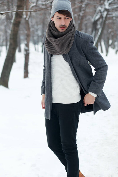 man walking in winter park 