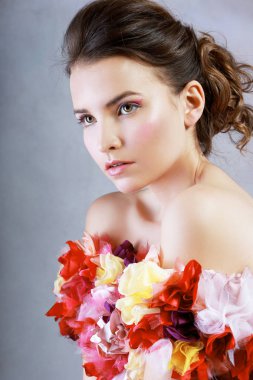 half length portrait of beautiful young woman wearing dress of flowers standing next to color background clipart