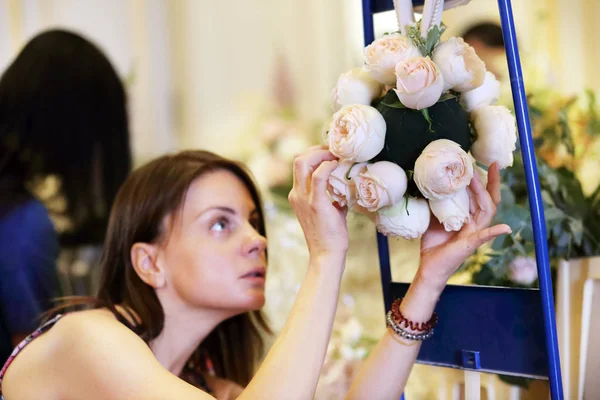 female florist making bride bouquet