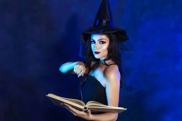 美丽年轻女子的半长肖像女巫礼服手持魔术棒 — 图库照片