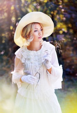 portrait of beautiful woman in victorian age dress and fancy hat walking outdoor clipart
