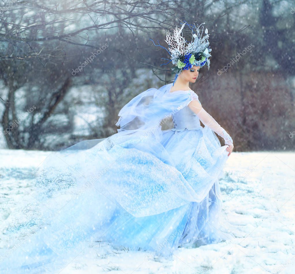 Winter Fairy or Snow queen, woman in light blue tulle dress outdoor wear floral crown