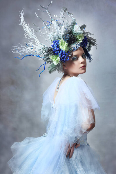Winter Fairy or Snow queen - woman in light blue tulle dress outdoor wear floral crown