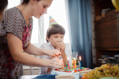 Anne oğula mum olan bir pasta yemek
