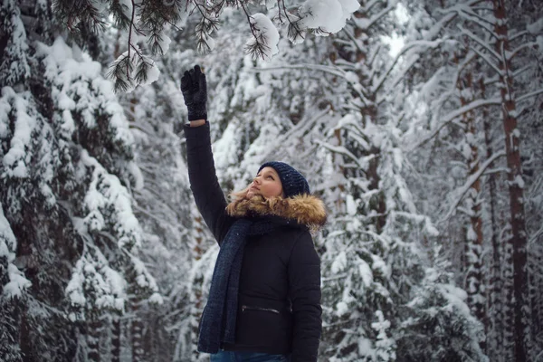 Счастливая молодая женщина играет со снегом — стоковое фото