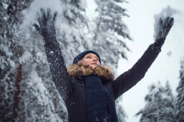 Happy young woman playing with snow — Stock Photo, Image