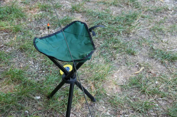 Folding portable shair fisherman on green grass — Stock Photo, Image