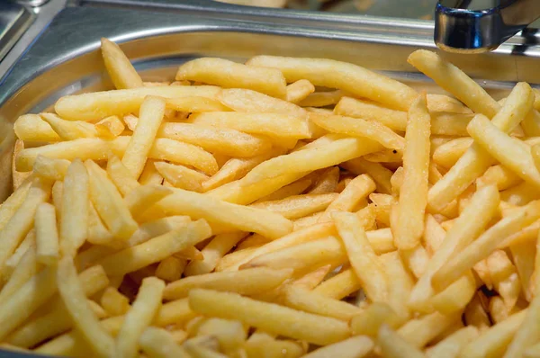 Golden fried potatoes fries on counter of restaurant fast food. — Stock Photo, Image
