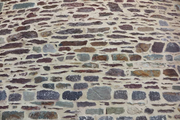 Fragment d'un mur de pierre comme fond — Photo