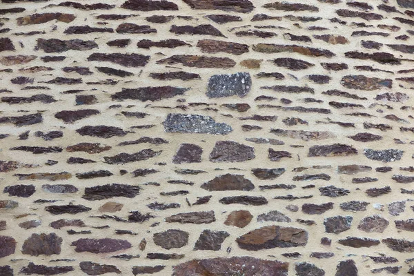 Fragment av en mur av sten som bakgrund — Stockfoto