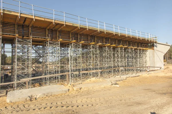 Byggande byggnadsställningar byggt under en överfart över motorvägen — Stockfoto
