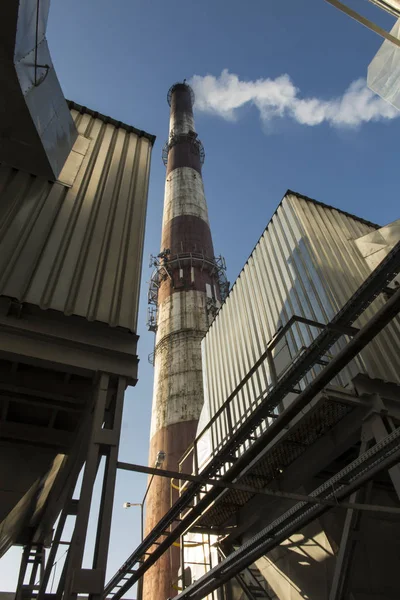 Tall chimney and fragments of dust collectors — Stock Photo, Image