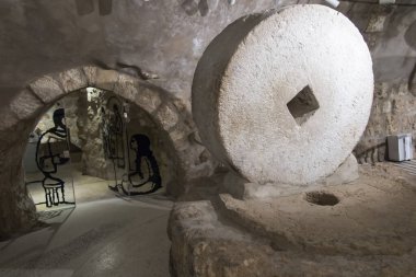 Bethany, Betania, Israel January 31, 2020: Commemorative interior of the house of Mari, Martha and Lazarus, Jesus' friends in Bethany and in it an olive oil press, stone for grinding grain and others.