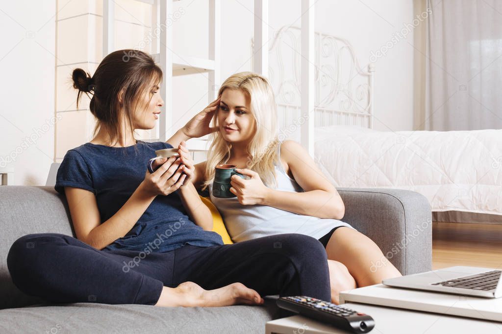 Beautiful young women in a relationship drinking coffee