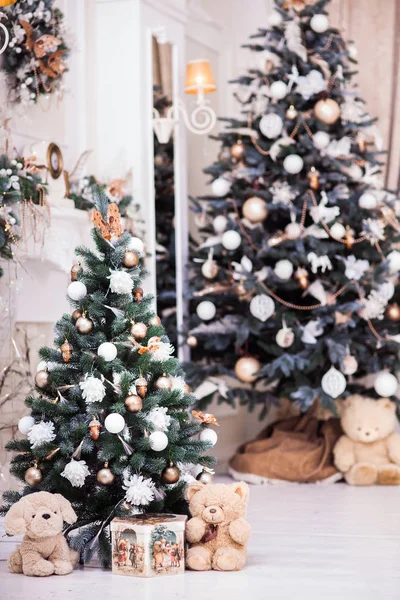 Dos árboles de Navidad decorados con caja de regalo cerca de la chimenea clásica — Foto de Stock