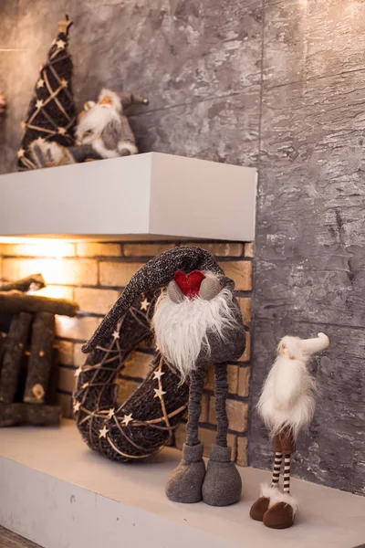 Unusual small Santa staying near fireplace — Stock Photo, Image
