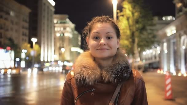 Cute Girl Smiles against the Background of the Night City — Stock Video