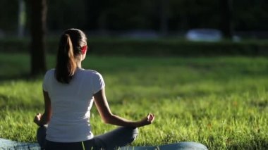 Kadın trafik arka plan karşı parkta meditasyon