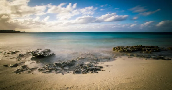 Rocks on grace bay beach — Stock Photo, Image