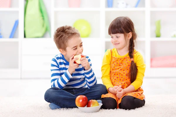 Funny little boy eating apple — Stock Photo, Image