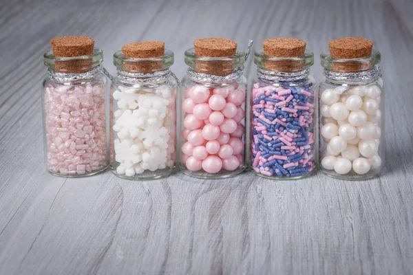 Verschiedene Bonbons Streusel in Mini-Glasflasche lizenzfreie Stockfotos