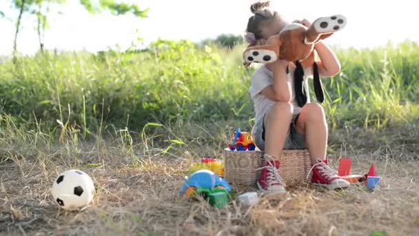 Rindo e garoto tímido com brinquedo — Vídeo de Stock