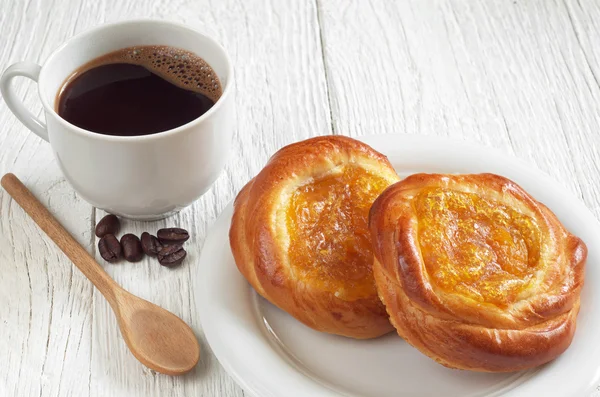 Buns and coffee cup — Stock Photo, Image