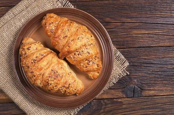 Two croissants with seeds
