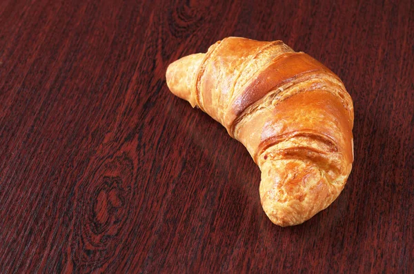 Croissant on desk — Stock Photo, Image